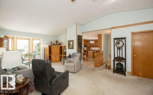 Bay window with natural light, recessed lighting, wood trim details, and a neutral wall palette - 11007 108 Avenue, Westlock, AB 
