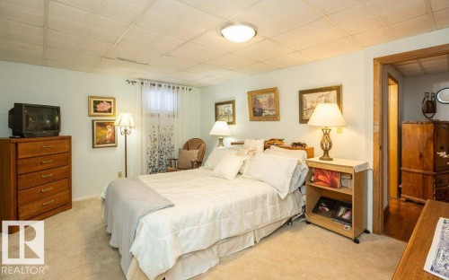 Carpeted flooring with a tiled ceiling and recessed lighting - 11007 108 Avenue, Westlock, AB 