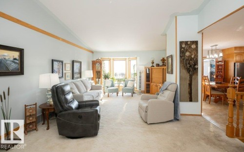 Vaulted ceilings enhance the living area, featuring a prominent bay window - 11007 108 Avenue, Westlock, AB 