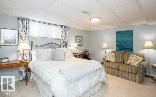 Recessed window with privacy blinds, wall-to-wall carpeting, and a drop ceiling - 11007 108 Avenue, Westlock, AB 