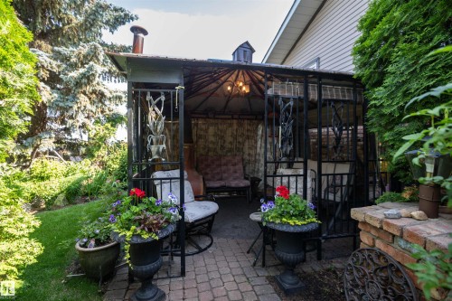Paved patio featuring a gazebo with a metal frame and built-in lighting - 11007 108 Avenue, Westlock, AB 