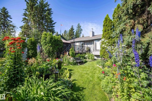 Landscaped garden featuring diverse plantings and a manicured lawn - 11007 108 Avenue, Westlock, AB 