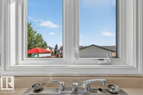 Double-hung window with white framing - 14527 32 Street Nw, Edmonton, AB 