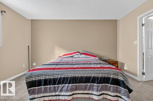 Neutral-toned walls, textured ceiling, and light-toned carpeting - 14527 32 Street Nw, Edmonton, AB 