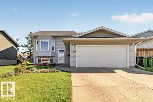 Split-level home featuring light grey siding and a bay window - 14527 32 Street Nw, Edmonton, AB 