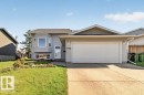 Split-level home featuring light grey siding and a bay window - 14527 32 Street Nw, Edmonton, AB 