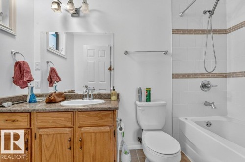 Vanity with a durable countertop, integrated sink, and wood-finish cabinetry - 14527 32 Street Nw, Edmonton, AB 