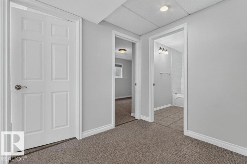 Recessed lighting, carpet flooring, white interior doors, and light gray wall paint - 14527 32 Street Nw, Edmonton, AB 