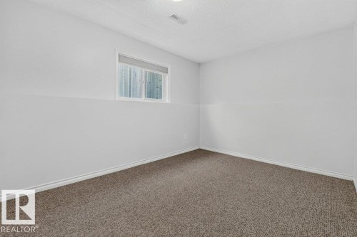 Neutral wall paint, window with blinds, and carpeted flooring - 14527 32 Street Nw, Edmonton, AB 