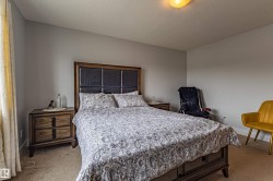 Neutral-toned room featuring a soft carpeted floor and light grey wall paint - 