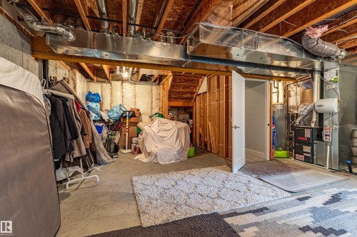 Unfinished basement featuring exposed wood joists and concrete flooring - #14 4835 Wright Dr Sw Sw, Edmonton, AB - Indoor Photo Showing Basement