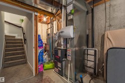 Utility area featuring a furnace, water heater, and ductwork - 