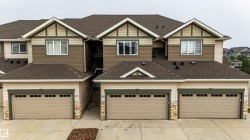 Multi-unit exterior showcasing a combination of horizontal siding, shake siding, and stone veneer accents - 