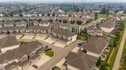 Aerial perspective showcasing a residential community with numerous single-family homes - 