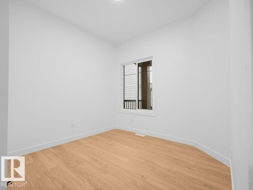 Window with white trim and wood-finish flooring - 912 17 Ave Nw, Edmonton, AB 