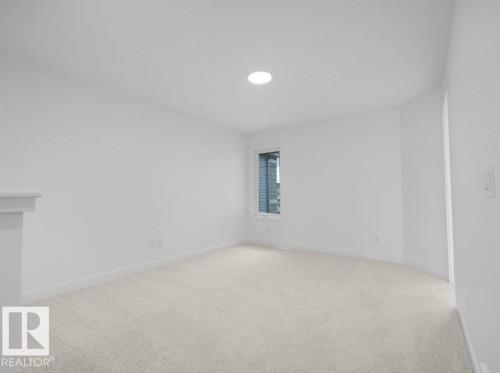 Neutral-toned carpeting, single window, and a ceiling-mounted light fixture - 912 17 Ave Nw, Edmonton, AB 