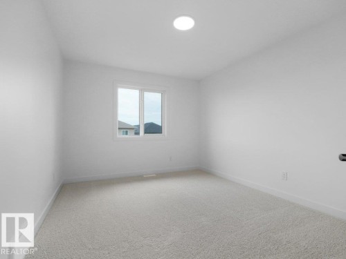 Recessed ceiling light, white walls, carpeted flooring, and a double-pane window - 912 17 Ave Nw, Edmonton, AB 