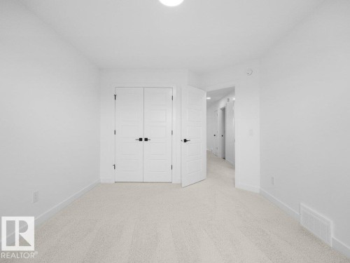 Recessed ceiling light, carpeted flooring, white walls, white paneled doors, black door hardware - 912 17 Ave Nw, Edmonton, AB 
