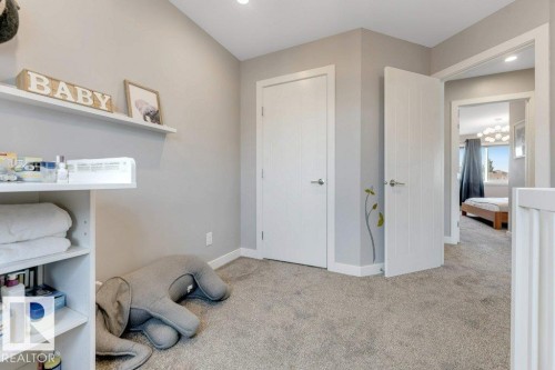 Recessed lighting illuminates neutral-toned walls and grey carpeting - #45 16903 68 St Nw, Edmonton, AB 