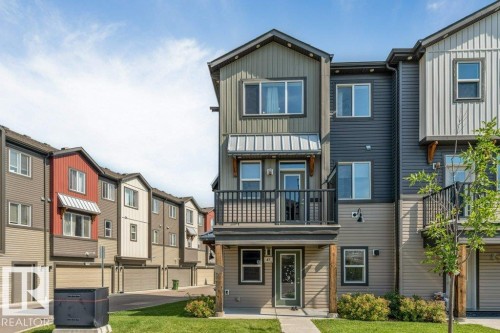 Three-story facade with mixed siding, covered entry, and a second-level balcony - #45 16903 68 St Nw, Edmonton, AB 