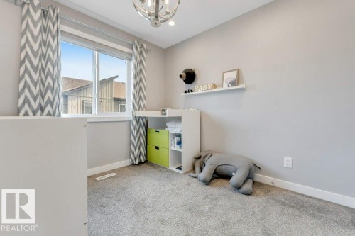Wall-to-wall carpeting, single window with white trim, contemporary ceiling light fixture, neutral wall paint, and white baseboards - #45 16903 68 St Nw, Edmonton, AB 