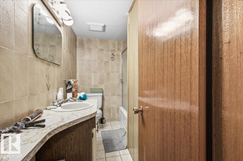 Tile flooring complemented by tiled walls - 13235 82 Street Nw, Edmonton, AB 