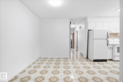 Tile flooring with a decorative pattern, white walls, and overhead lighting - 13235 82 Street Nw, Edmonton, AB 