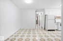 Tile flooring with a decorative pattern, white walls, and overhead lighting - 13235 82 Street Nw, Edmonton, AB 