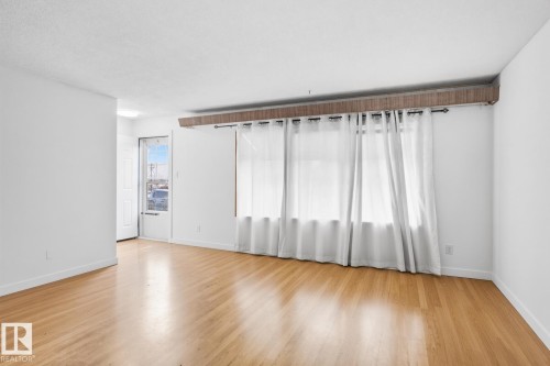 Hardwood flooring throughout, white painted walls, and ceiling-mounted window treatments - 13235 82 Street Nw, Edmonton, AB 