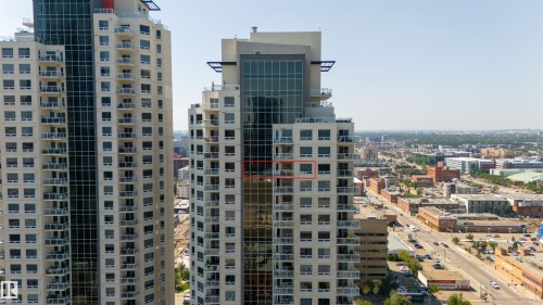 Modern high-rise residential building with a cityscape backdrop - #2205 10226 104 St Nw, Edmonton, AB - Outdoor With Facade