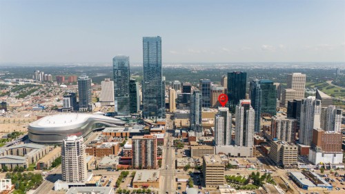 Aerial perspective of a metropolitan area featuring numerous high-rise buildings and a prominent, modern stadium structure - #2205 10226 104 St Nw, Edmonton, AB - Outdoor With View
