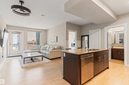 Open-concept living space with light wood-finish flooring - #2205 10226 104 St Nw, Edmonton, AB - Indoor