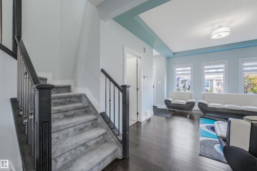 Staircase with carpeted treads and dark wood newel posts - 6453 177A Avenue Nw, Edmonton, AB 