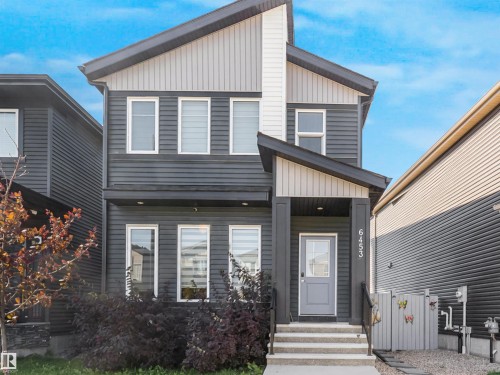 Contemporary exterior with dual-tone horizontal siding, prominent front porch with an overhang, and a light-colored entry door with frosted glass - 6453 177A Avenue Nw, Edmonton, AB 