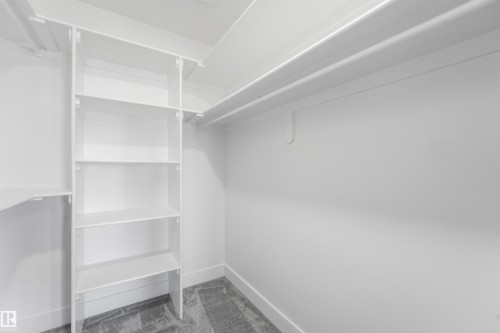 Built-in shelving system with multiple adjustable shelves and hanging rods - 6453 177A Avenue Nw, Edmonton, AB 