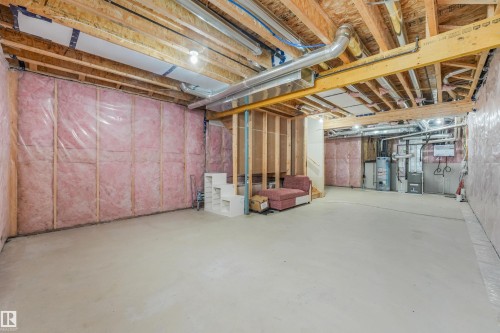Unfinished basement with concrete flooring, exposed wood joists, and insulated walls - 6453 177A Avenue Nw, Edmonton, AB 