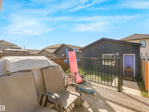 Wood-finish deck with black metal railings - 6453 177A Avenue Nw, Edmonton, AB 