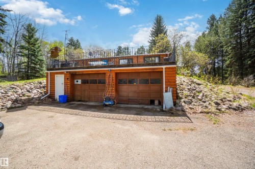 Two-car garage with wood-finish doors and a wood-sided exterior - 910 Hermitage Avenue, Rural Parkland County, AB - Outdoor