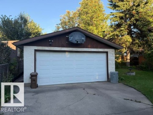 White sectional garage door with external lighting - 3 Morgan Crescent, St. Albert, AB 