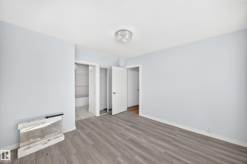 Light blue walls with wood-finish flooring - Edmonton, AB 