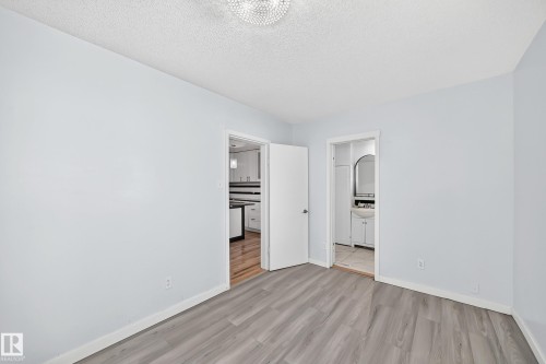 Wood-finish flooring with light-toned walls - Edmonton, AB 