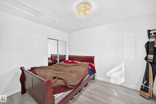 Recessed lighting, ceiling-mounted fixture, sliding closet doors, wood-finish flooring - Edmonton, AB 