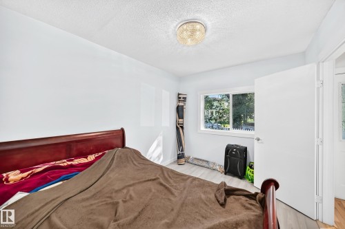 Recessed window with white trim, wood-finish flooring, and overhead lighting - Edmonton, AB 
