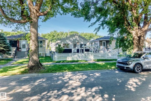 White picket fence, mature trees, front porch, exterior steps, sidewalk - Edmonton, AB 