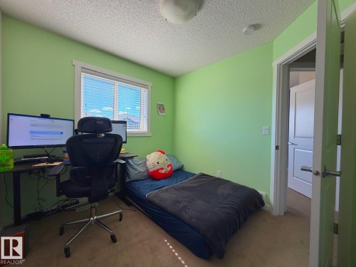 Window with horizontal blinds, neutral carpet flooring, and a flush mount ceiling light fixture - 5169 Chappelle Rd Southwest, Edmonton, AB 