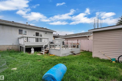 Multi-level wood deck with railings, sliding glass door access, and exterior siding - 3227 145 Avenue Nw, Edmonton, AB 
