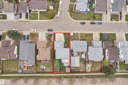Property lot featuring a residential structure with an attached driveway and a private backyard space - 3227 145 Avenue Nw, Edmonton, AB 
