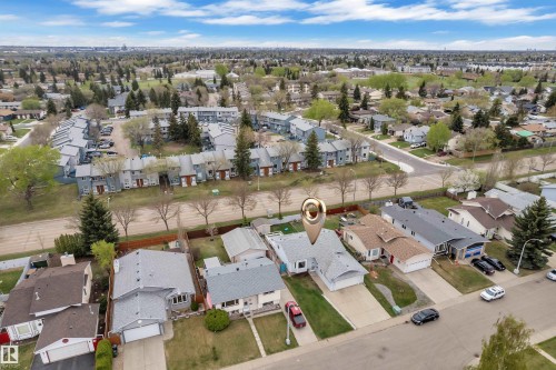 Single-story residence with a gray shingle roof, attached garage, and paved driveway - 3227 145 Avenue Nw, Edmonton, AB 