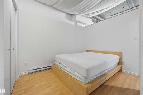 Recessed ceiling, wood-finish flooring, white walls, baseboard heating - #1313 10024 Jasper Av Nw, Edmonton, AB 