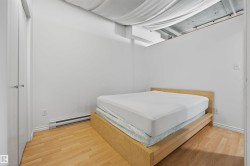 Recessed ceiling, wood-finish flooring, white walls, baseboard heating - 